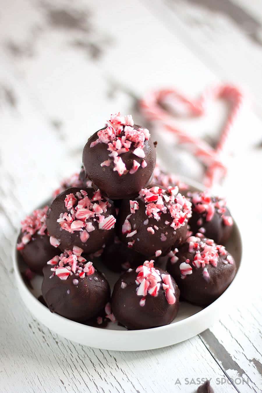 Crushed candy canes, crushed Oreo cookies, cream cheese, and melted dark chocolate result in the easiest, most refreshing, and festive dessert ever - Chocolate Peppermint Oreo Truffles!