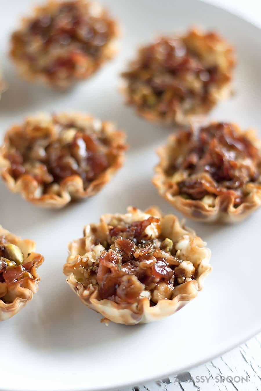 Bacon and goat cheese bites served in mini phyllo cups