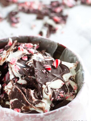 Sleigh the holidays with Boozy Marshmallow Peppermint Bark! Melted marshmallow mixed with peppermint schnapps, swirled on melted dark chocolate then topped with crushed candy canes.