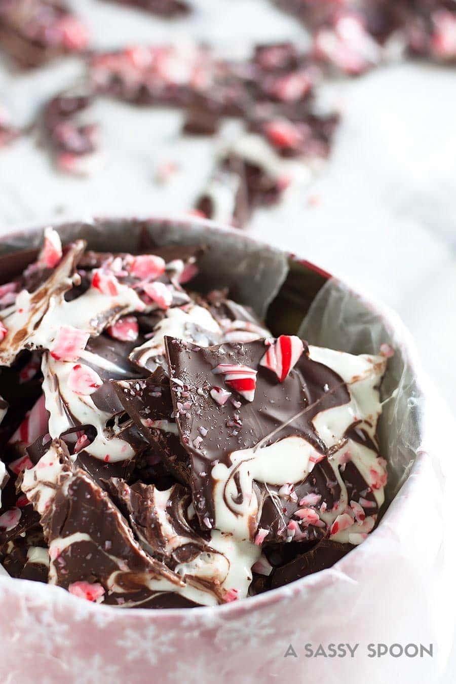 Sleigh the holidays with Boozy Marshmallow Peppermint Bark! Melted marshmallow mixed with peppermint schnapps, swirled on melted dark chocolate then topped with crushed candy canes.