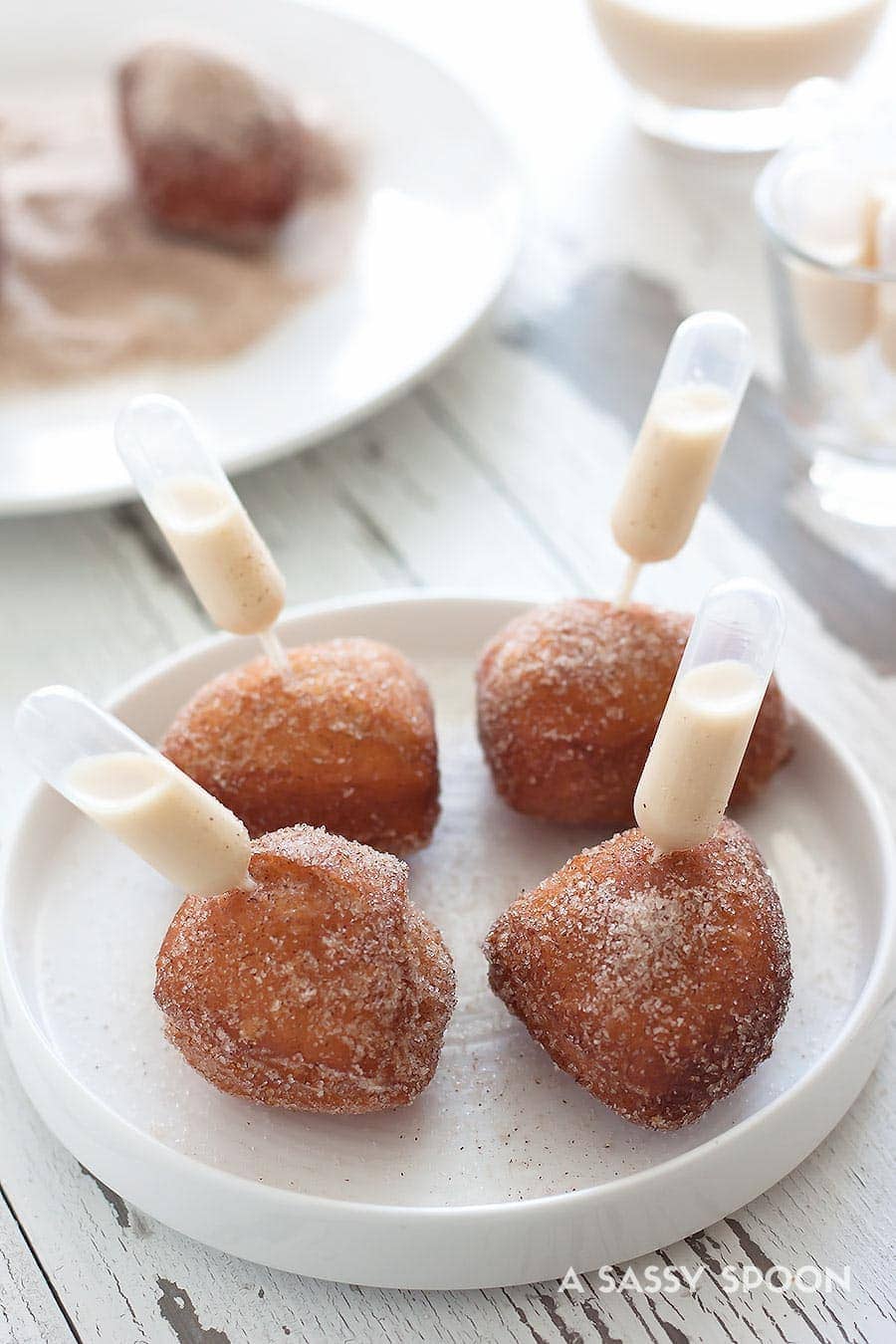 Four donut holes on a plate