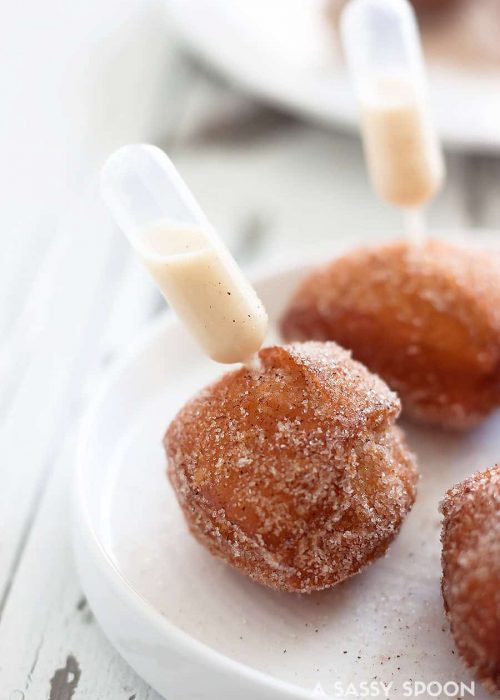 Quick and easy-to-make donut holes made in just minutes using refrigerated biscuit dough with a pipette of homemade coquito aka Puerto Rican eggnog!