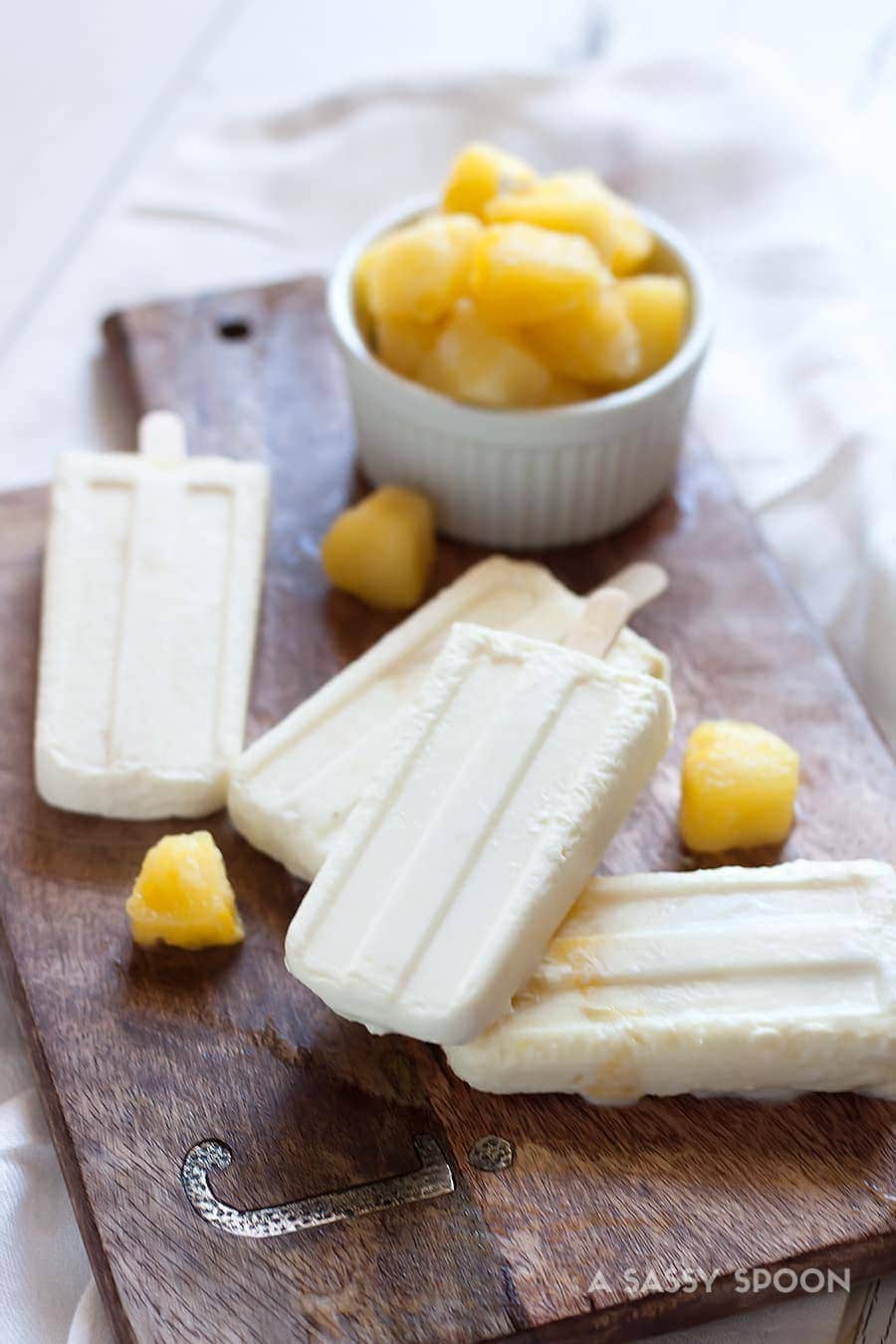 Pretend like it's Summer all year long with these easy to make creamy piña colada popsicles made with just 5 ingredients!