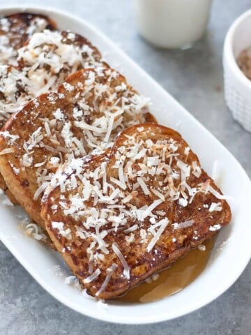 Dairy free French toast made with coconut milk, spiked with rum, and topped with toasted coconut flakes. Perfect for special occasions or Sunday brunch!