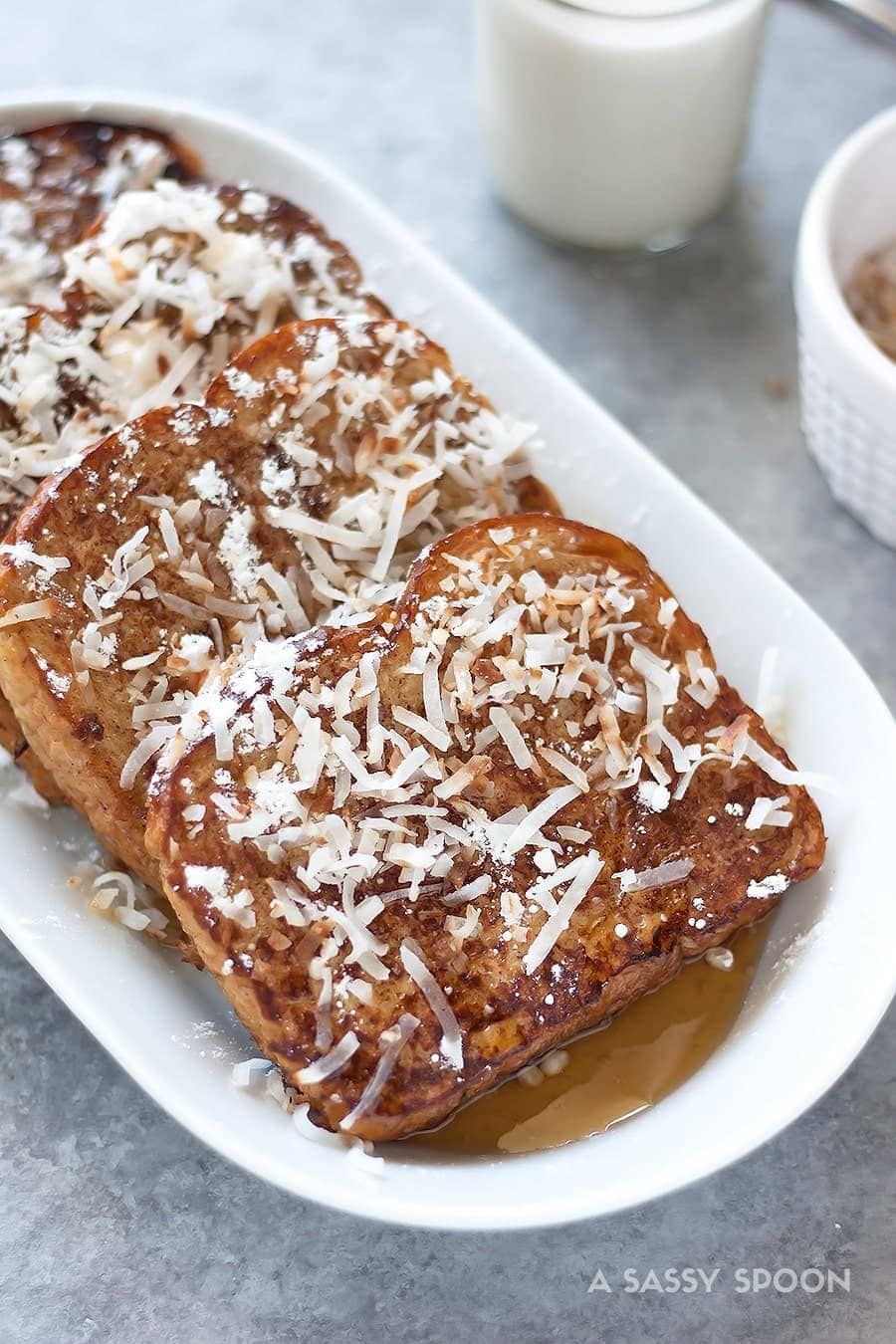 Dairy free French toast made with coconut milk, spiked with rum, and topped with toasted coconut flakes. Perfect for special occasions or Sunday brunch!