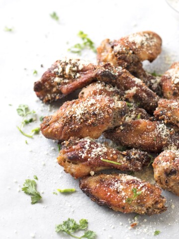 Parmesan chicken wings garnished with cilantro