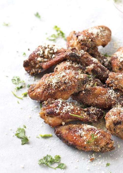 Parmesan chicken wings garnished with cilantro