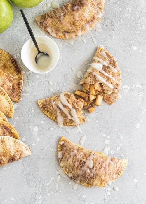 These baked apple pie empanadas with a buttery brown sugar apple filling and a spiced rum icing drizzle are the perfect party snack!