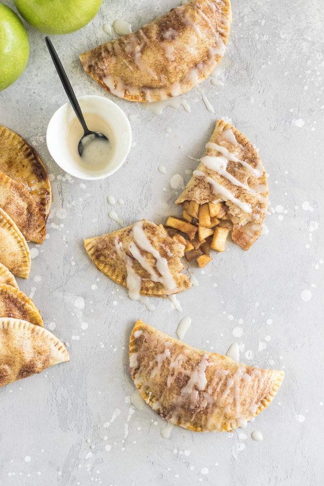 These baked apple pie empanadas with a buttery brown sugar apple filling and a spiced rum icing drizzle are the perfect party snack!