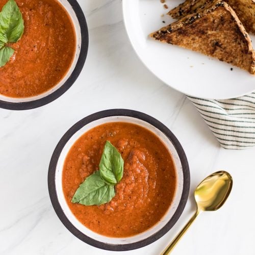 A deliciously simple homemade roasted tomato basil soup that you can enjoy all year round with a melty grilled cheese made with Irish whiskey butter!