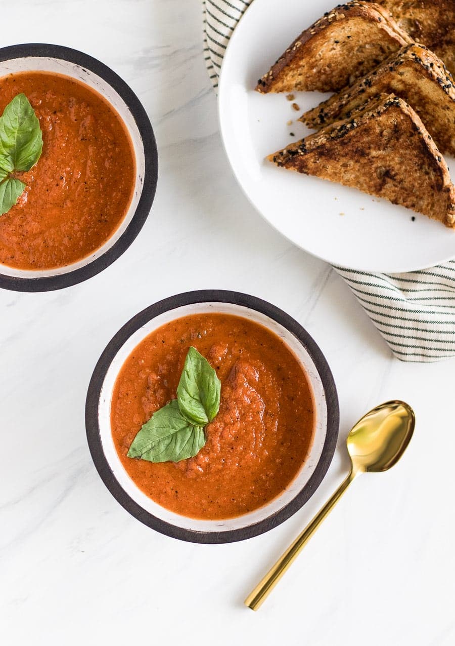 A deliciously simple homemade roasted tomato basil soup that you can enjoy all year round with a melty grilled cheese made with Irish whiskey butter!