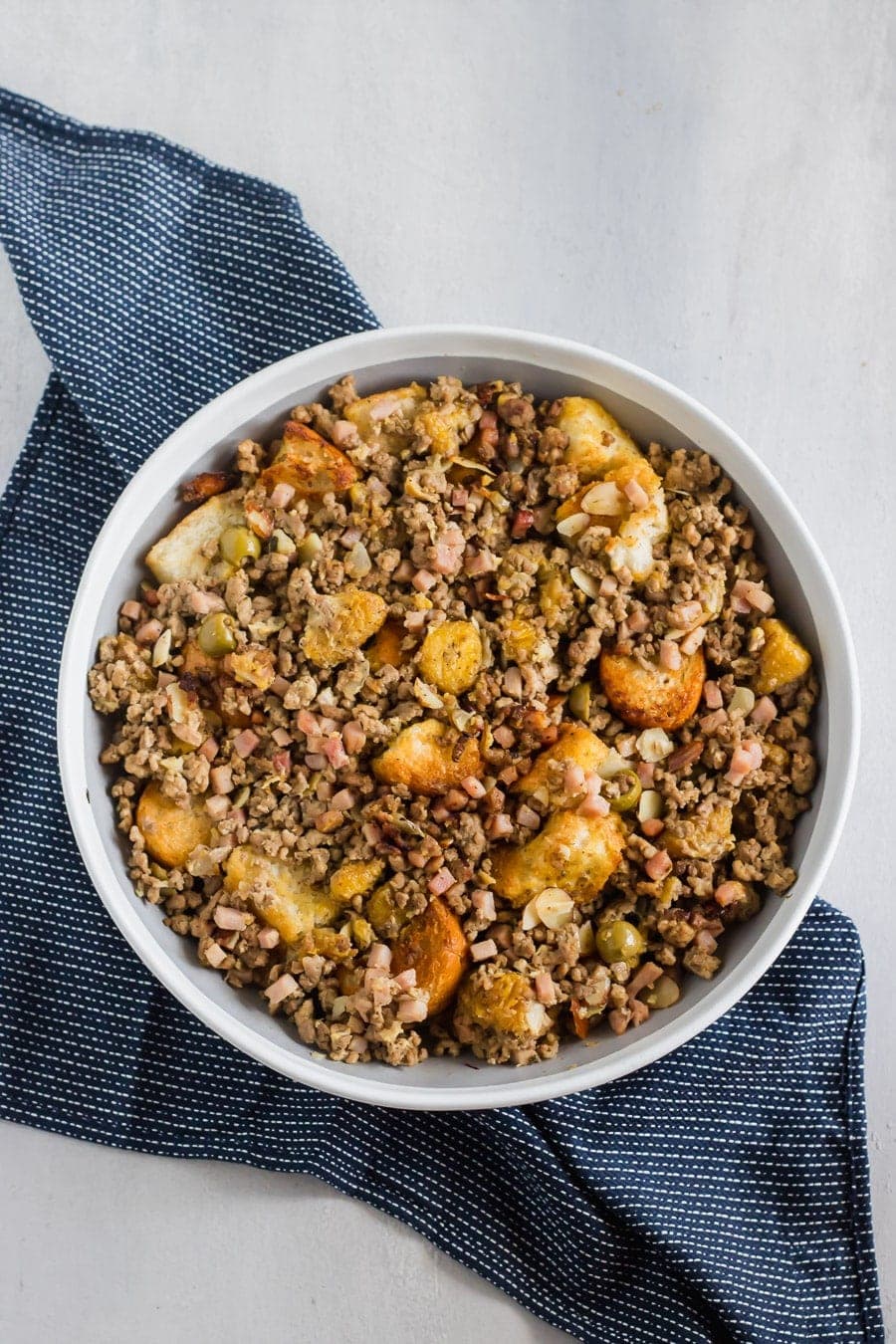 Cubes of toasty French bread mixed with ground beef, ground pork, diced ham, herbs, spices, sliced almonds, chopped olives, and sweet plantains! The BEST stuffing you'll ever try!