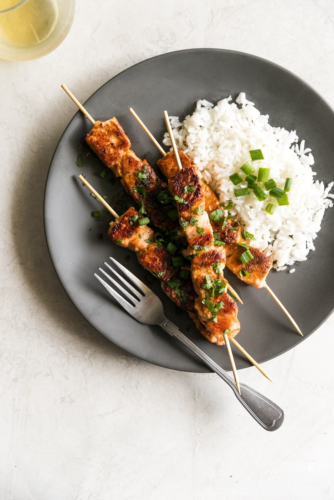 Salmon marinated in honey, garlic, soy sauce, fresh lime juice then cooked on skewers for 10 minutes in a cast iron skillet. A simple yet gourmet weeknight meal!