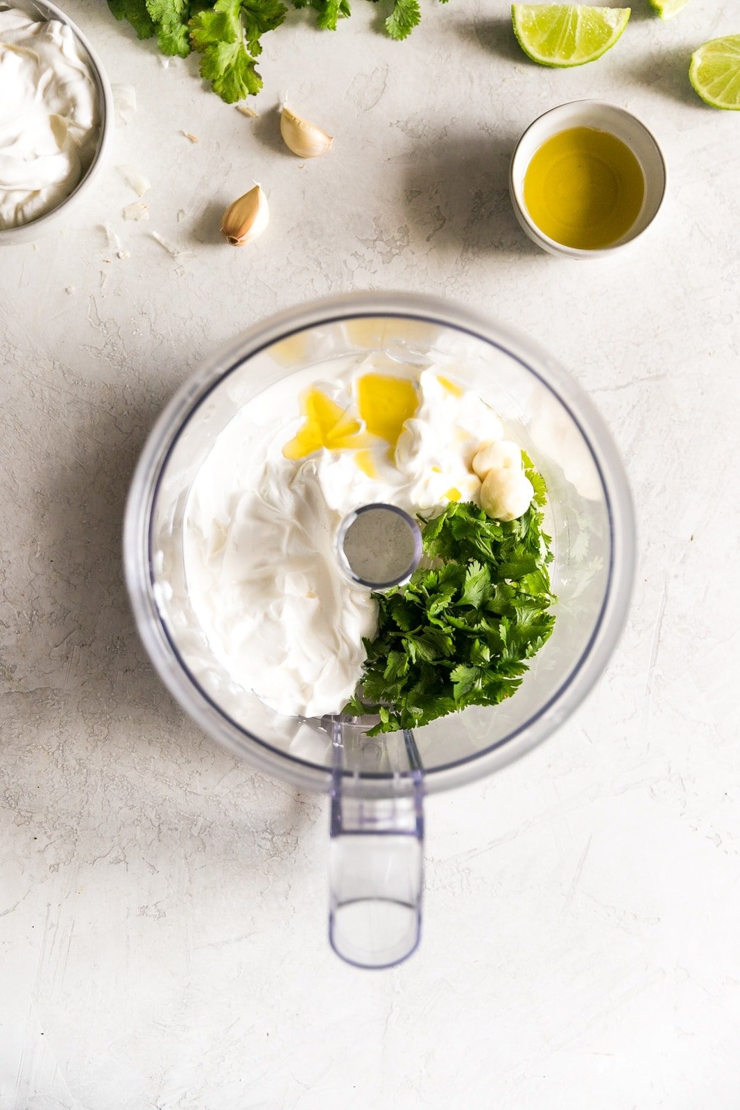 Sour cream, cilantro, garlic, and other ingredients in the food processor
