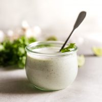 cilantro garlic sauce in jar with spoon inside the jar