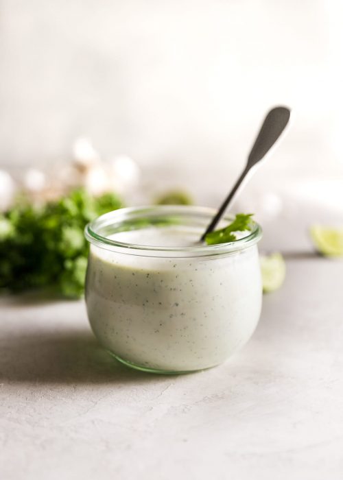 cilantro garlic sauce in jar with spoon inside the jar