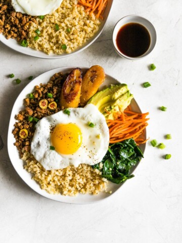 Inspired by Korean bibimbap, this healthy-ish Cuban bibimbap bowl has ground turkey (picadillo), seasoned cauliflower rice, sautéed garlic spinach, carrots, avocado, and sweet plantains. Colorful, flavorful and delicious!