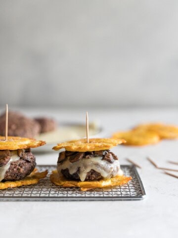 Flavorful black bean burgers topped with melted Swiss cheese and sautéed mushrooms with two twice fried plantains as buns. A delicious Cuban twist on a veggie burger!