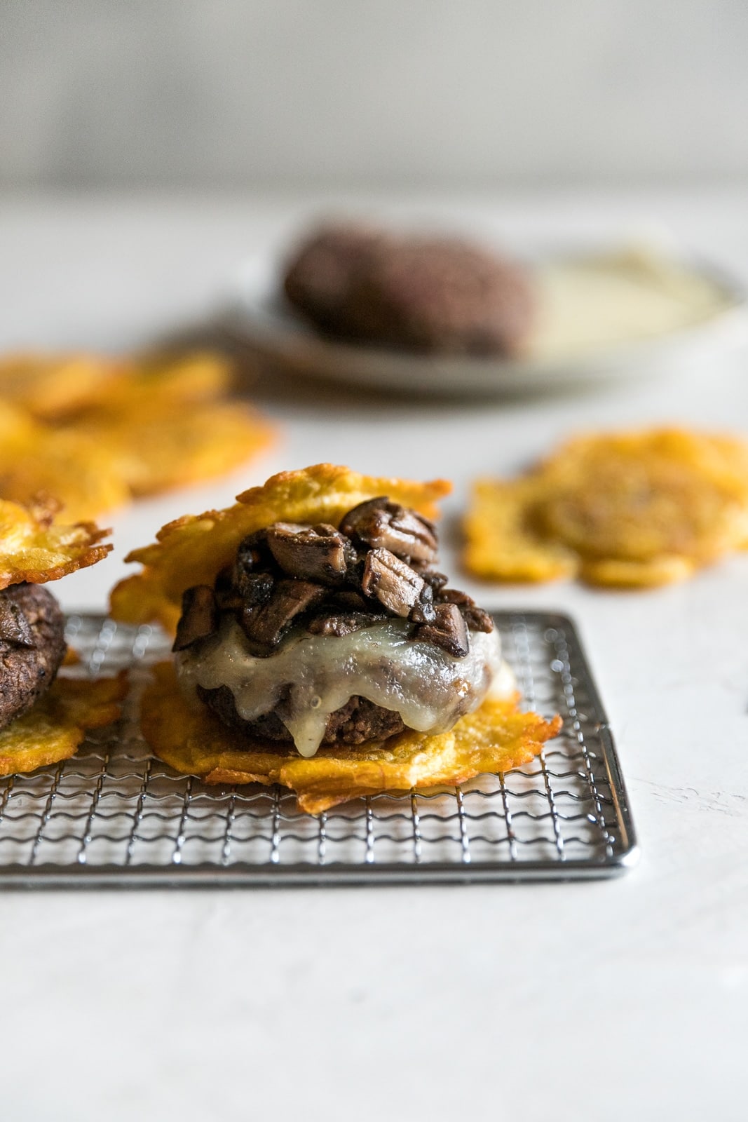Flavorful black bean burgers topped with melted Swiss cheese and sautéed mushrooms with two twice fried plantains (tostones) as buns. A delicious Cuban twist on a veggie burger!
