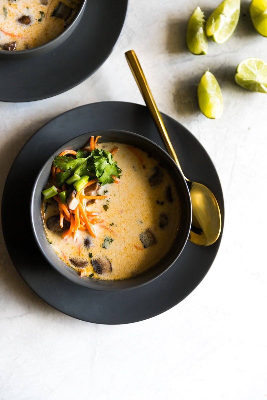 Bowl of Thai coconut soup topped with veggies