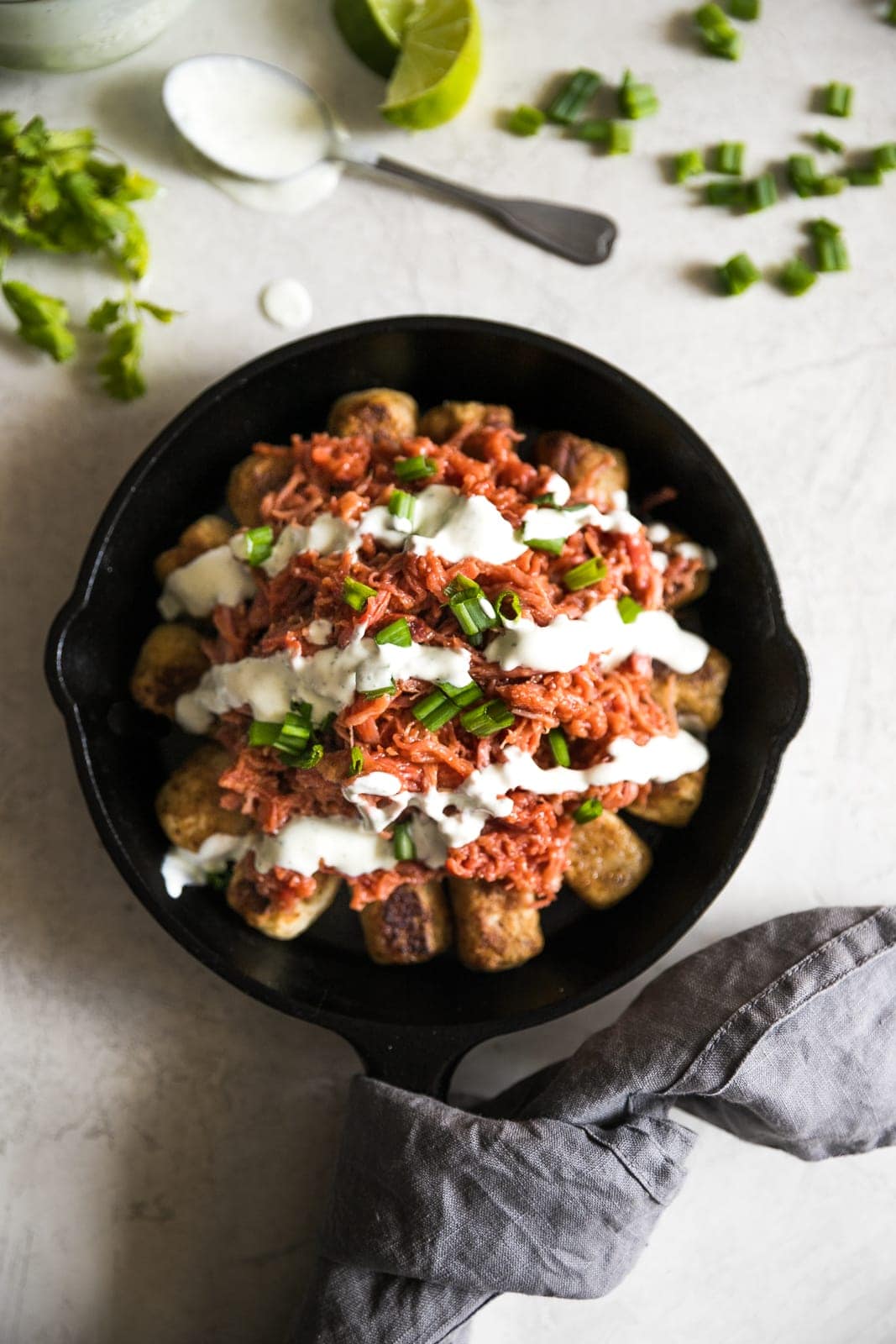Pulled Pork Yuca Tots with Cilantro Garlic Sauce. Yuca, aka cassava, turned into tots topped with juicy bbq pulled pork and cilantro garlic sauce!