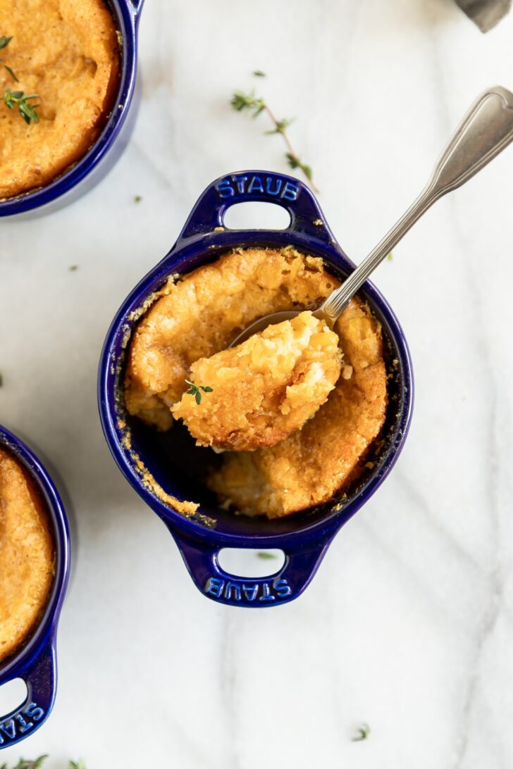 1. Mini French onion soup gratinée in blue Staub cocotte with melted cheese.