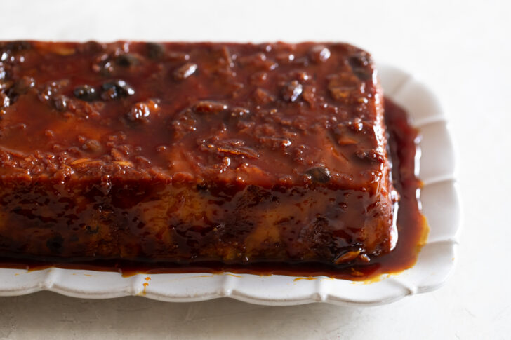 Savory barbecue pork ribs with rich sauce on white dish.