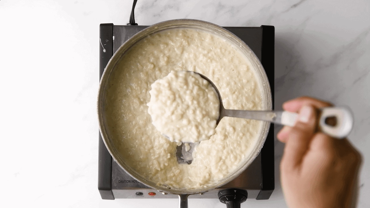 cooking Cuban rice pudding with sweetened condensed milk 