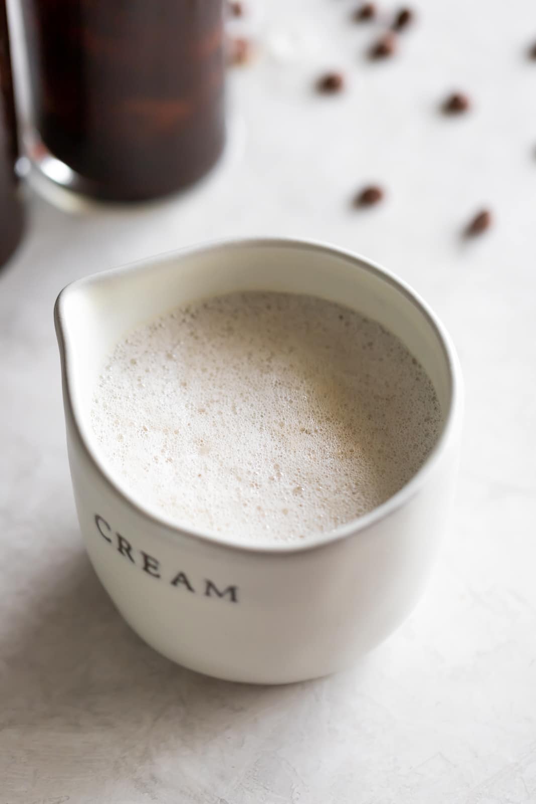 A frothy dairy-free cafe con leche (milk with coffee drink) made iced with sweetened Cuban coffee, creamer, and almond milk.