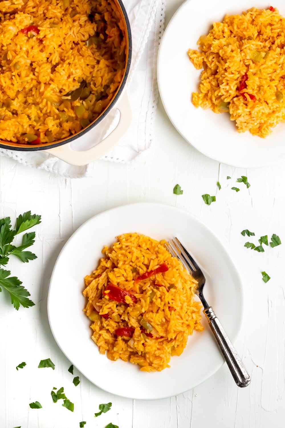 cuban yellow rice on a white plate on a white table