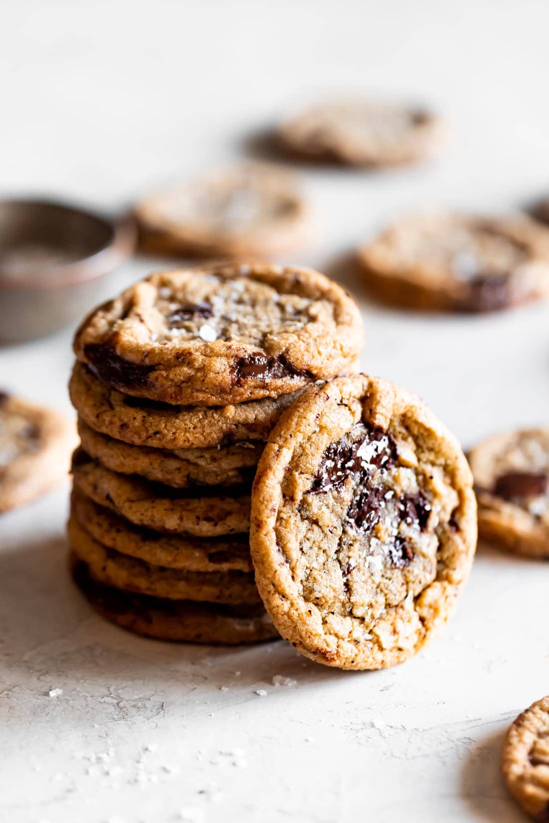 brown butter chocolate chip cookies stacked on top of each other on white background