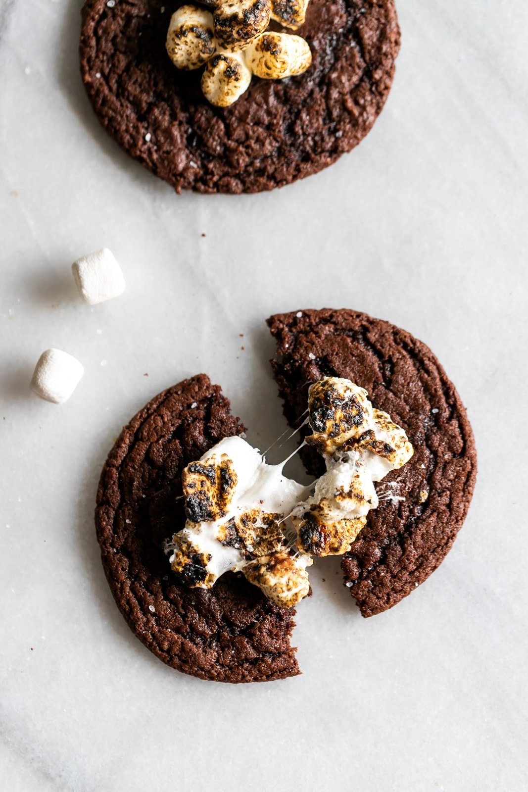 Boozy hot chocolate cookies! Rich, soft, and chewy chocolate cookies spiked with your favorite liqueur and topped with gooey torched mini marshmallows.