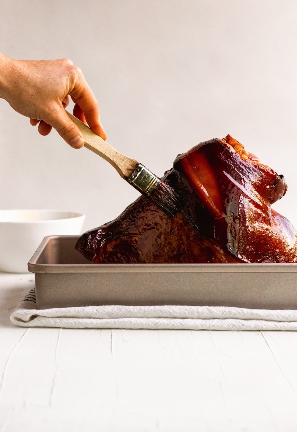 brown sugar glazed baked ham on a roasting pan