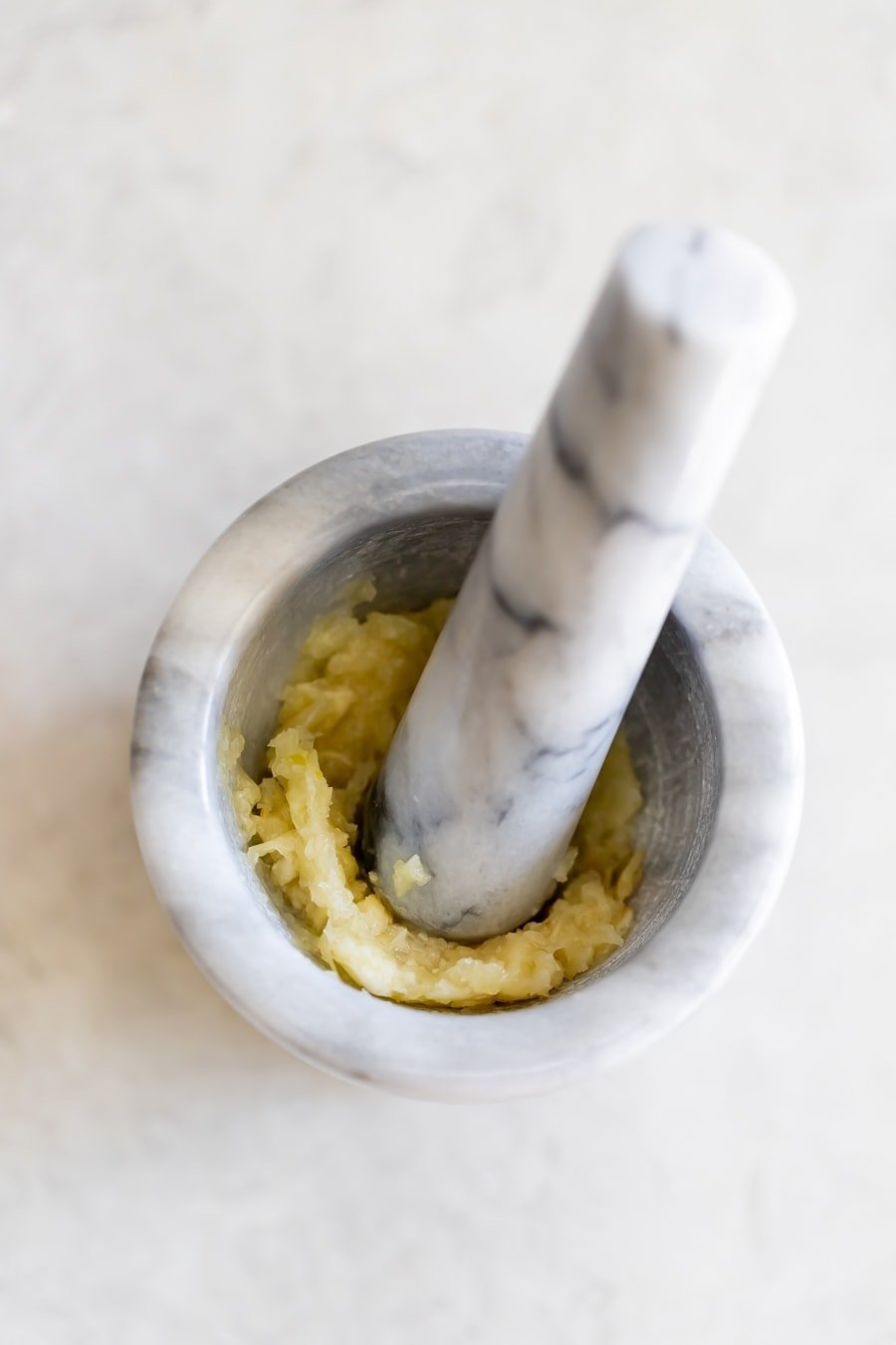 mashed garlic in mortar and pestle