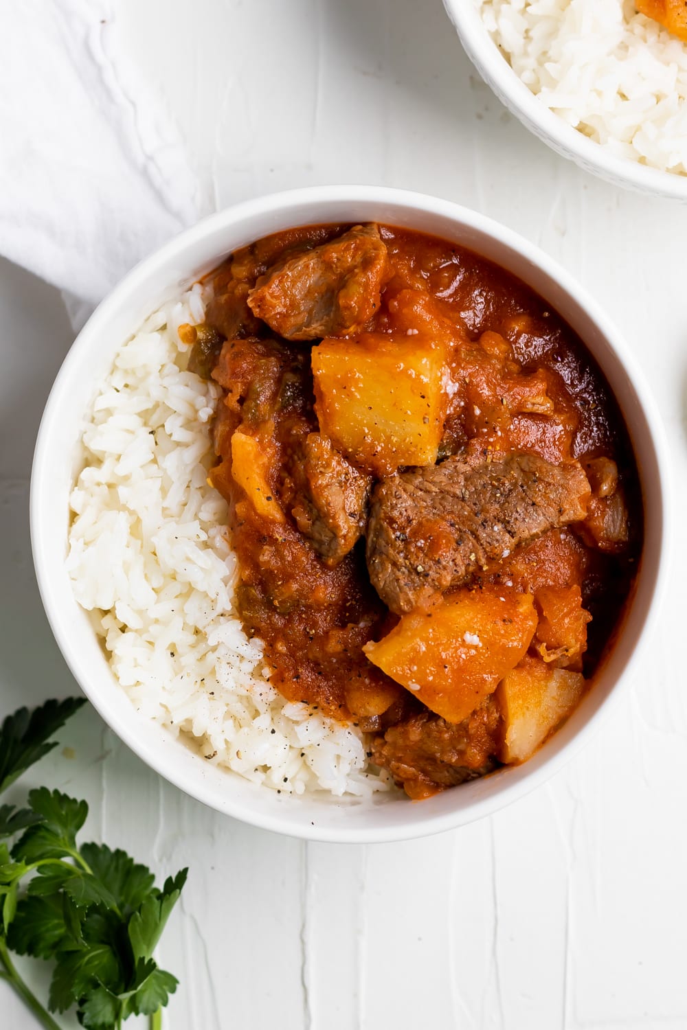 meat with potatoes (carne con papas) in a bowl with white rice