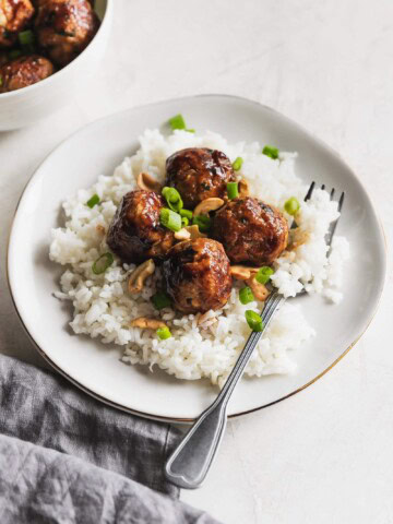 Juicy, tender chicken meatballs made with cashews, panko breadcrumbs, spices, and a super easy stir fry sauce. Perfectly cooked in 10 minutes!