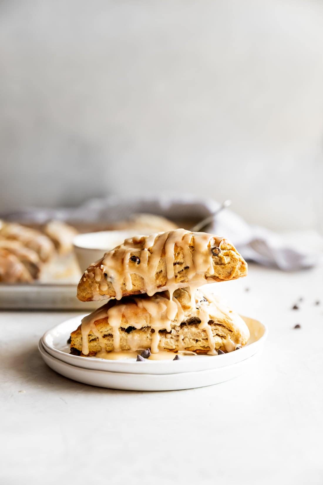 easy chai chocolate chip scones with espresso glaze stacked on top of one another