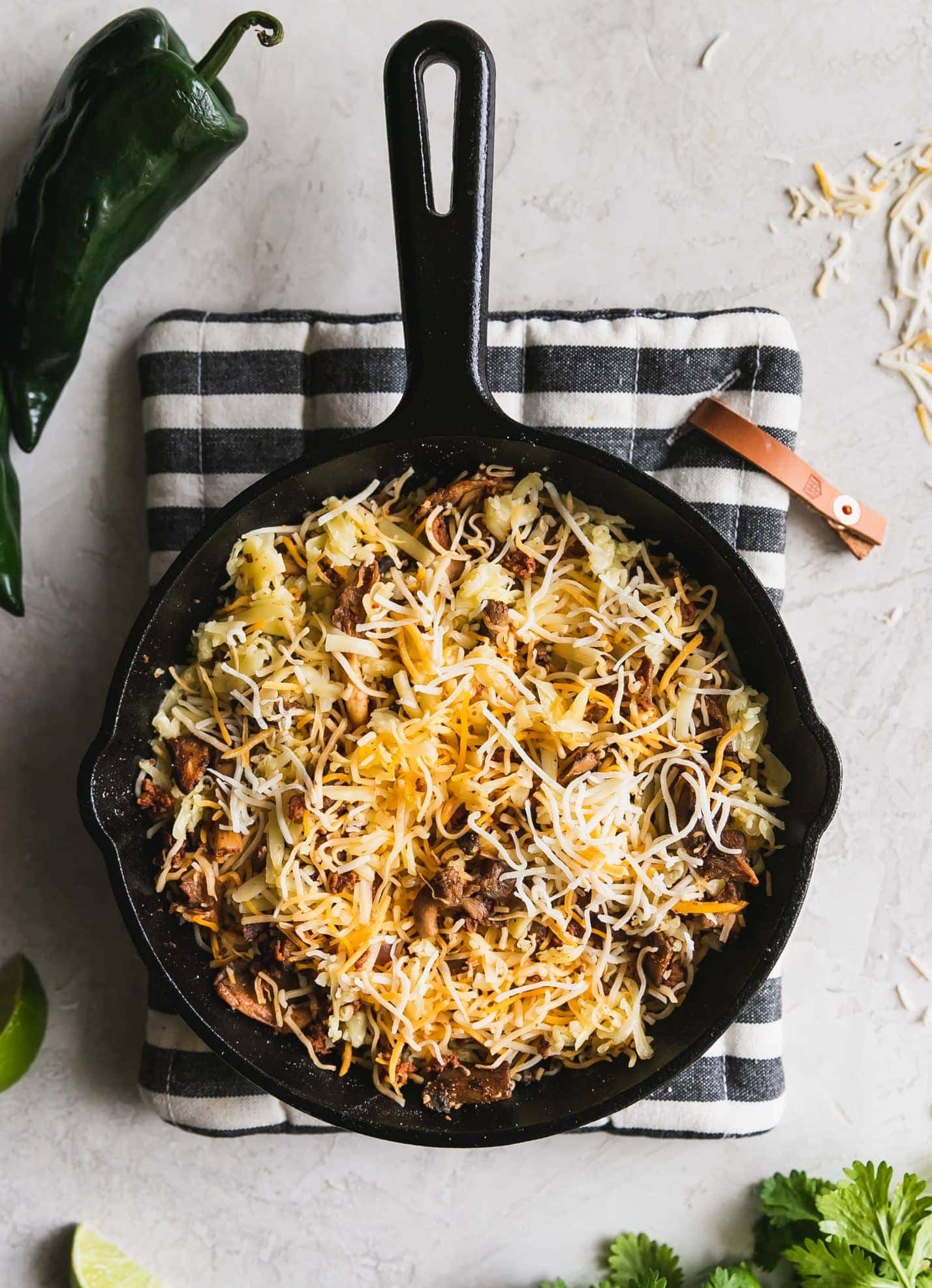 mushrooms, chorizo, peppers with shredded cheese in a cast iron before melting in the oven