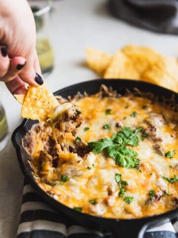 A smoky queso fundido dip made with chipotle mushrooms, roasted poblano peppers, and Mexican chorizo. Easy to make and perfect for game day! #quesofundido
