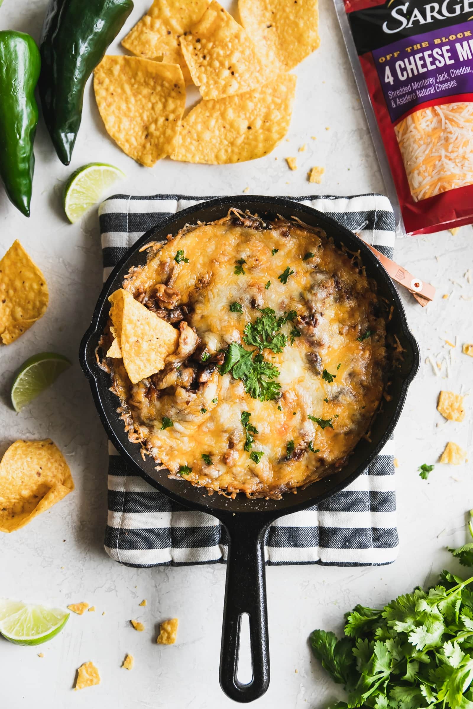melted cheese with chorizo, mushrooms, poblano peppers in a cast iron queso fundido