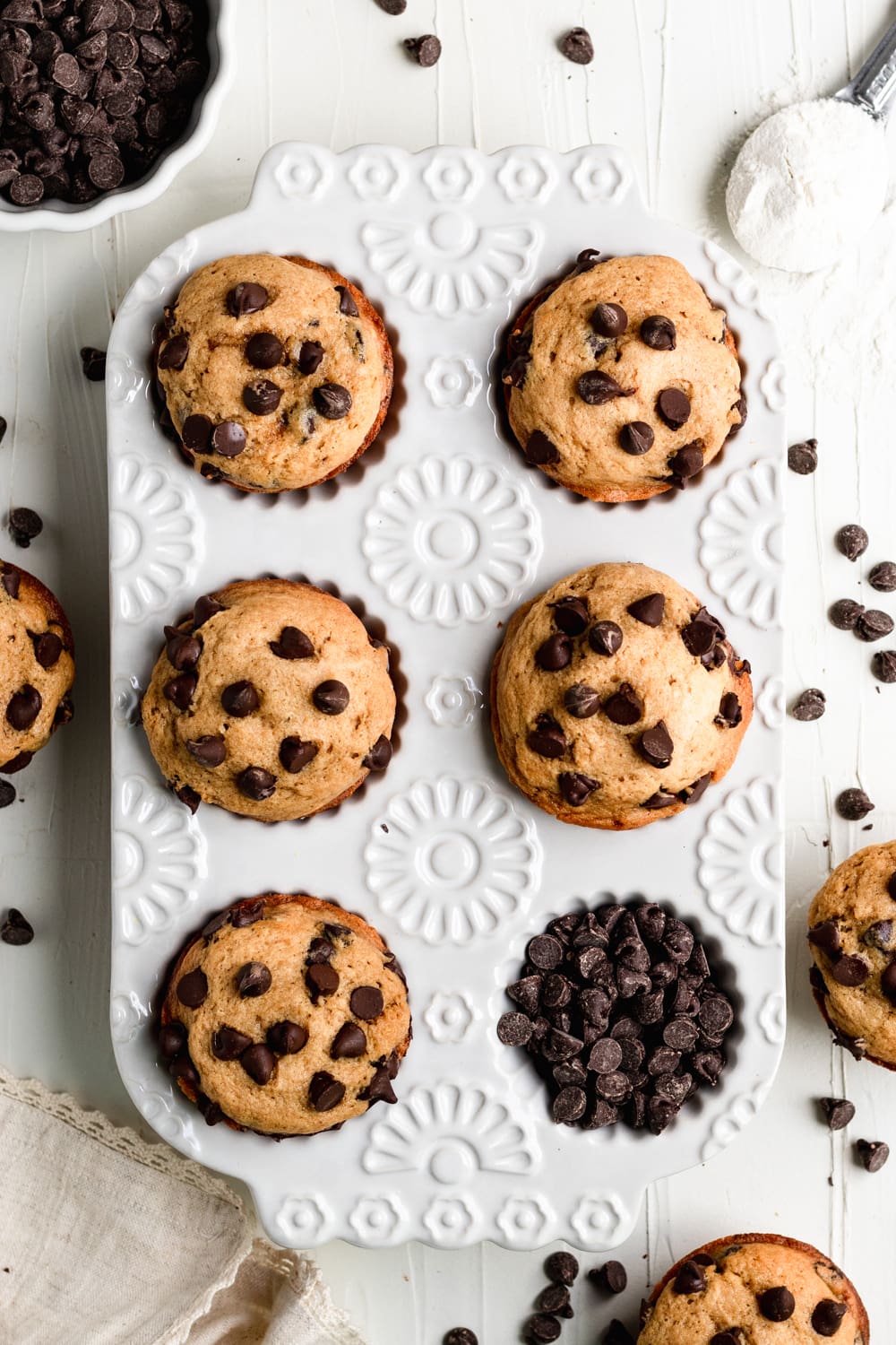 freshly baked chocolate chip muffins in a muffin tin 