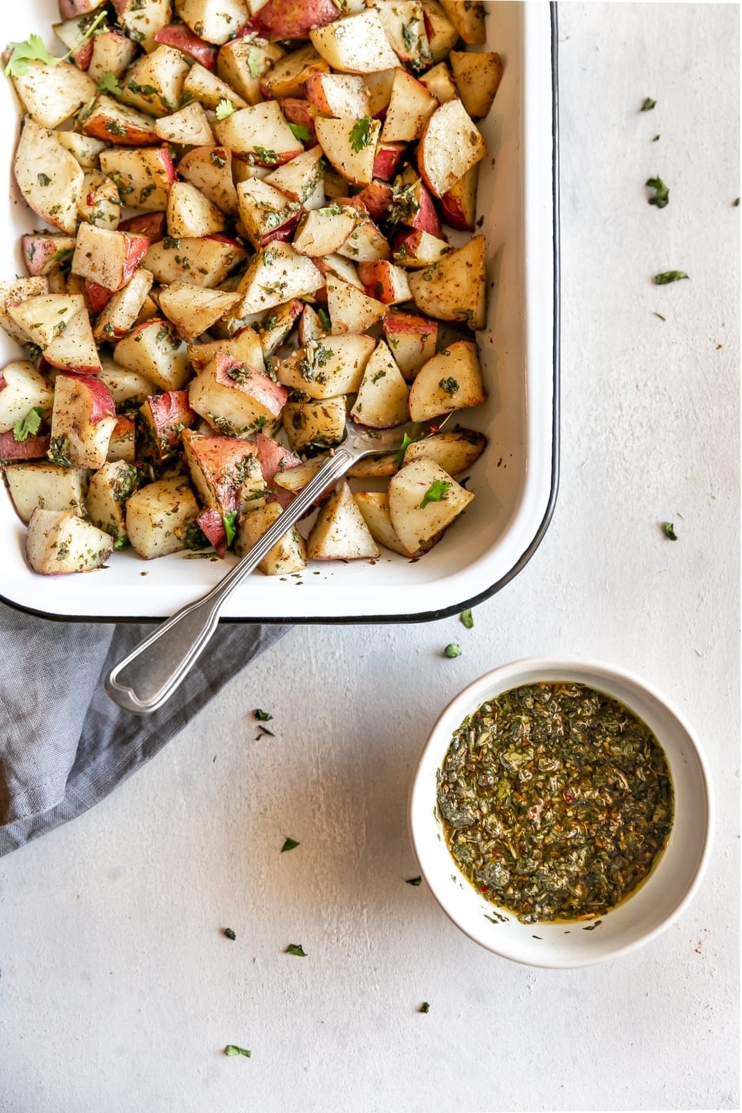 The easiest side dish ever. Roasted potatoes tossed in a delicious, super easy to make cilantro garlic chimichurri sauce!