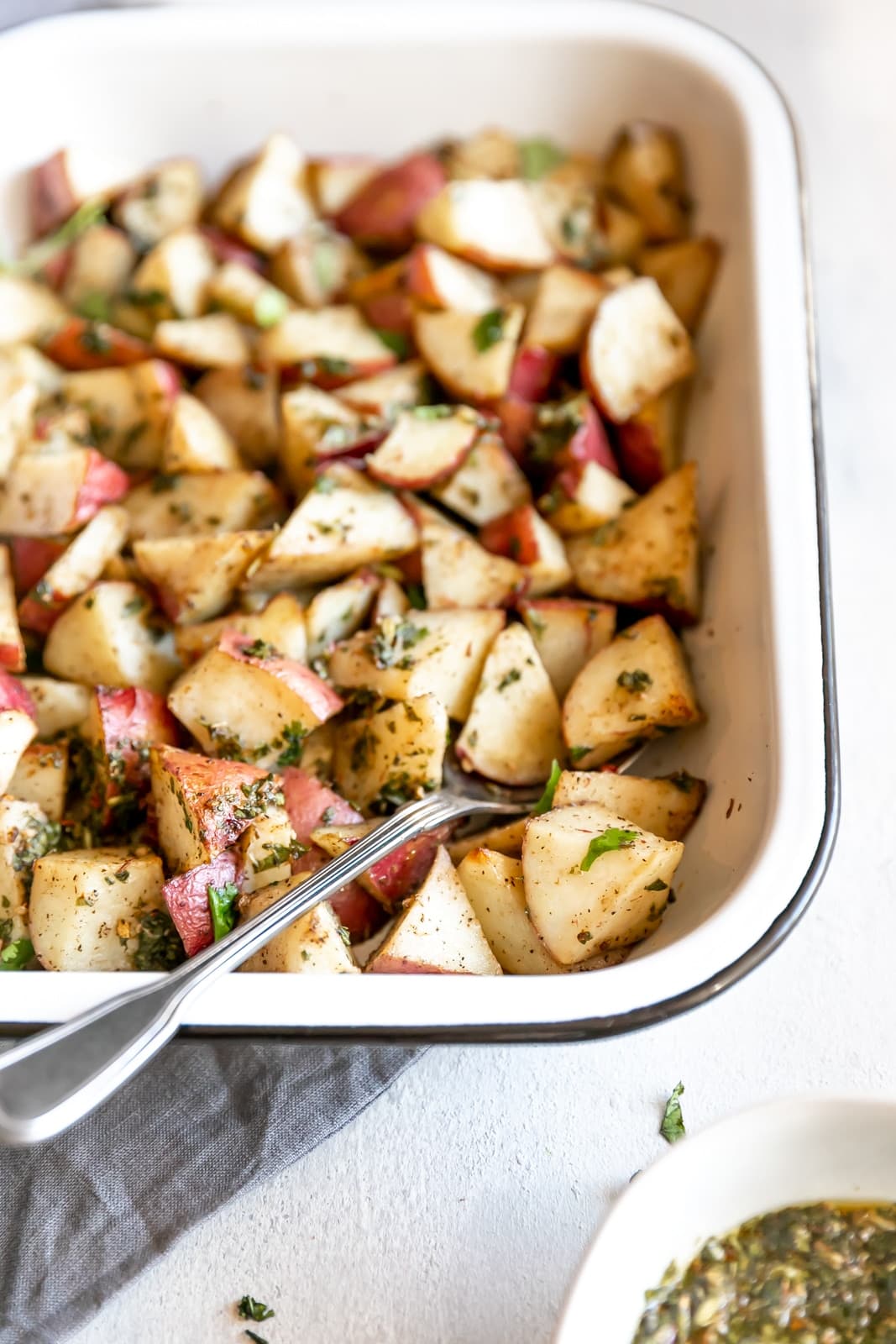 The easiest side dish ever. Roasted potatoes tossed in a delicious, super easy to make cilantro garlic chimichurri sauce!