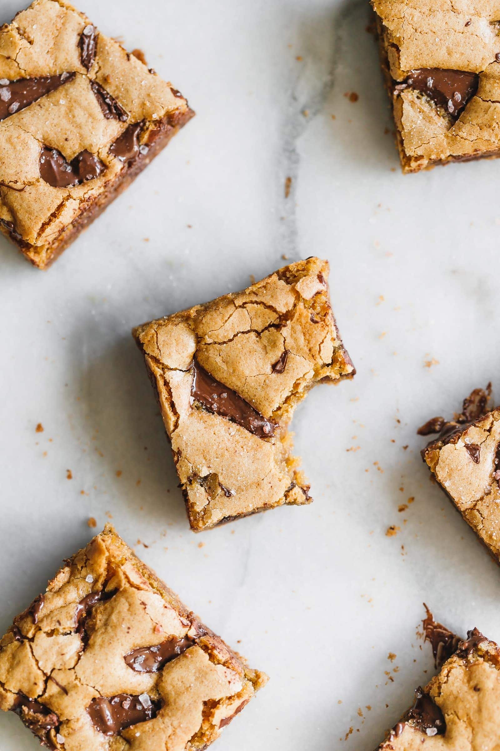 Incredibly soft, moist, thick and chewy chocolate chunk cookie bars made with coconut oil instead of butter, all in one bowl!
