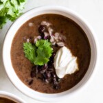 Rich, creamy, and easy-to-make Cuban black bean soup made with canned beans. Quick weeknight meal that is ready in just 25 minutes!