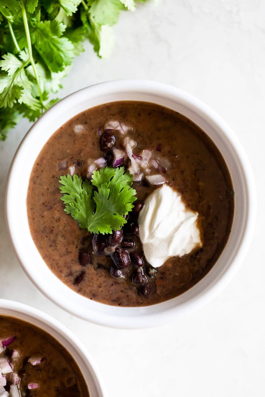 bowl of Cuban black bean soup with toppings