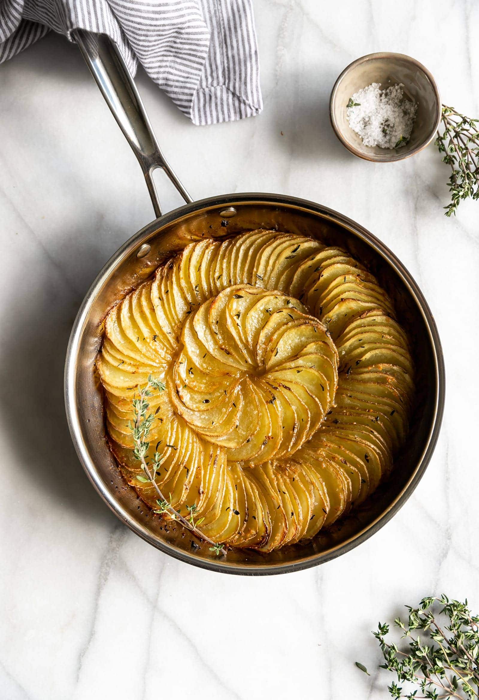 Thinly sliced gold potatoes tossed in garlic, butter, and thyme then roasted to perfection. An easy 5-ingredient side dish for any occasion!