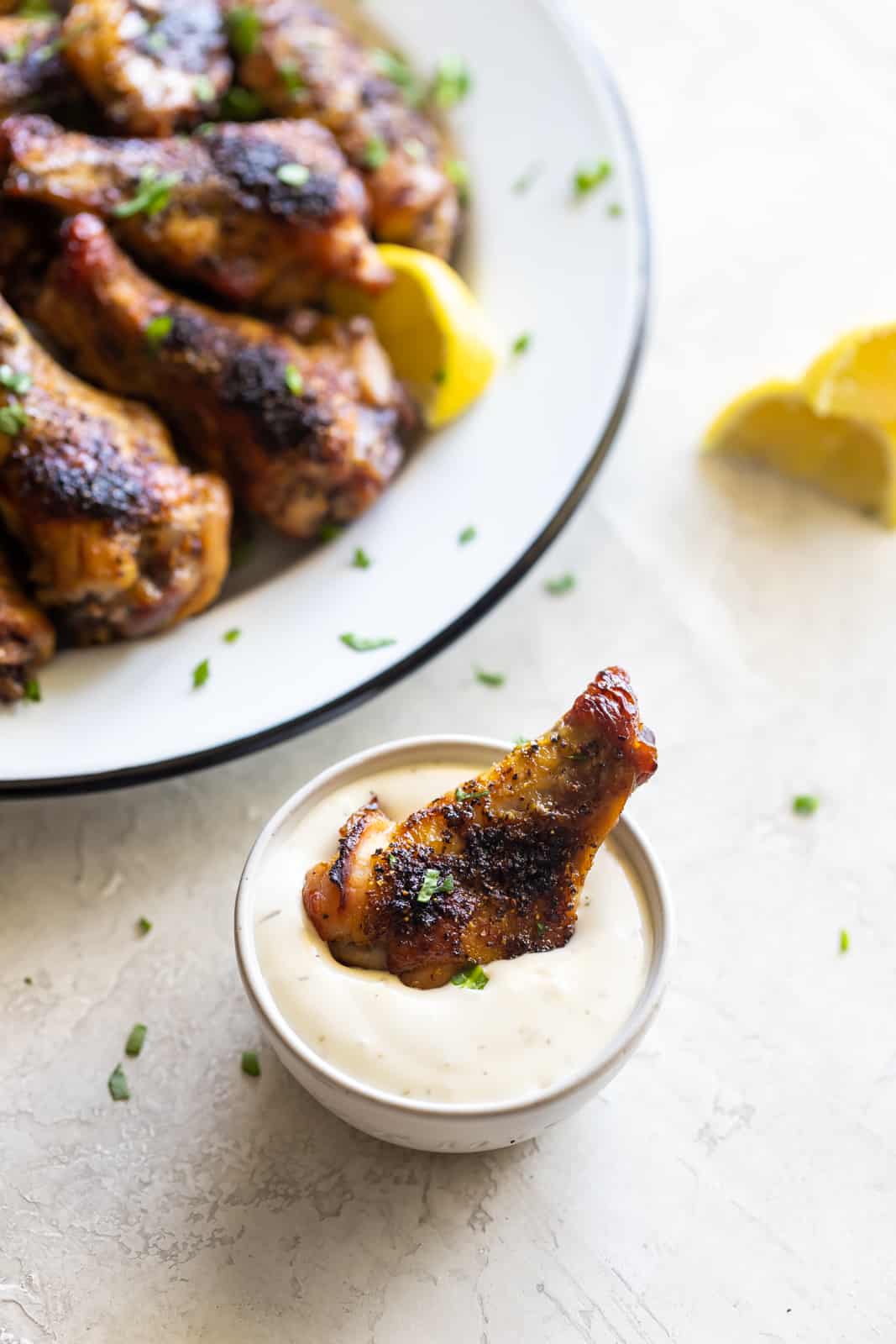 Lemon pepper chicken wing dipped in garlic sauce