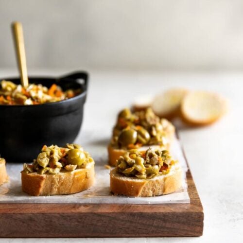 A simple yet irresistible appetizer made with tart, briny olives, capers, fresh garlic, pepper, and olive oil then served on toasted baguette slices brushed with olive oil.