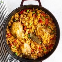Staub dutch oven with cooked Cuban yellow rice with chicken (arroz con pollo)